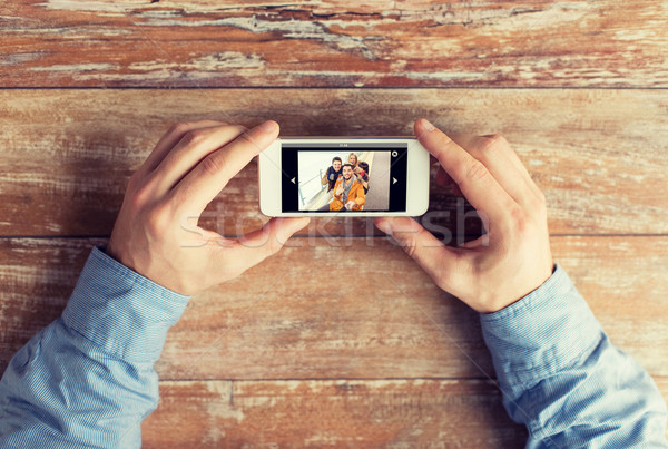 close up of male hands with photo on smartphone Stock photo © dolgachov
