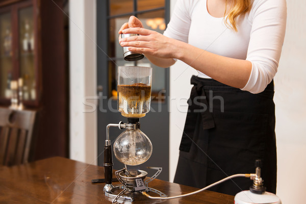 close up of woman with siphon coffee maker and pot Stock photo © dolgachov