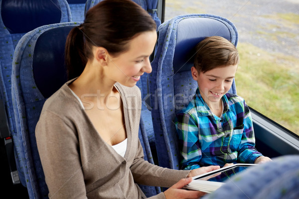 happy family with tablet pc sitting in travel bus Stock photo © dolgachov