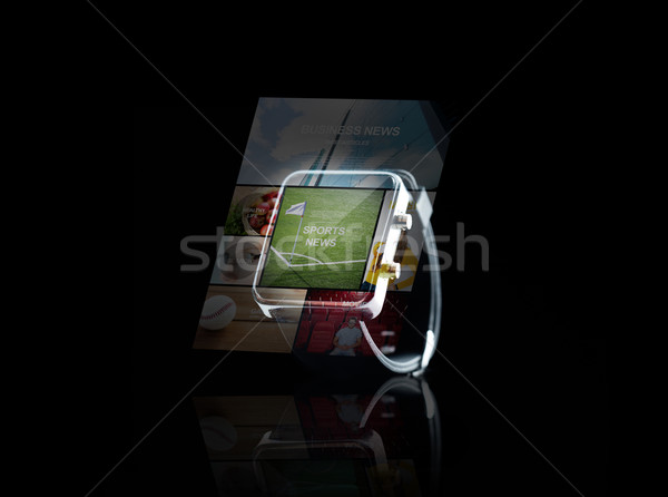 close up of smartwatch with sport news application Stock photo © dolgachov