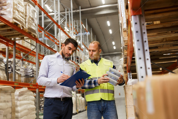Stock photo: worker and businessmen with clipboard at warehouse