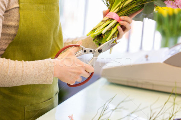 close up of florist making bunch at flower shop Stock photo © dolgachov