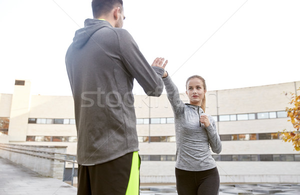 woman with trainer working out self defense strike Stock photo © dolgachov