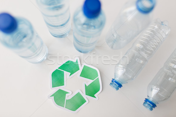 Stock photo: close up of plastic bottles and recycling symbol