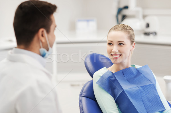 happy male dentist with woman patient at clinic Stock photo © dolgachov