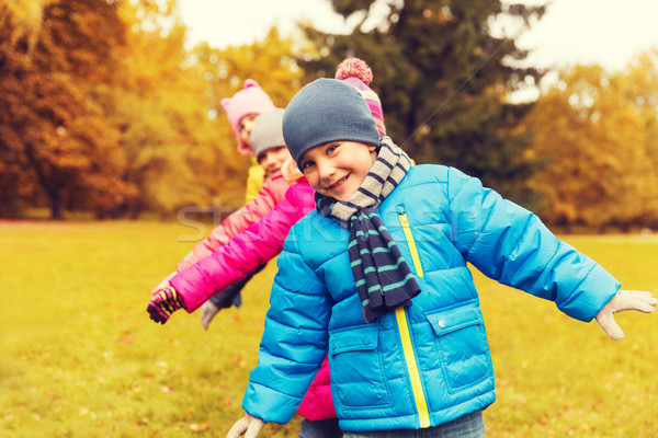 group of happy children having fun in autumn park Stock photo © dolgachov