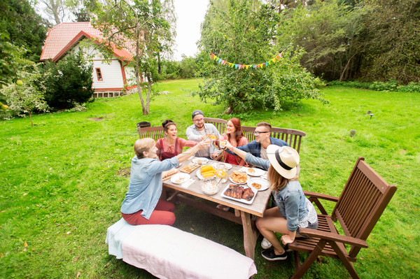 happy friends having dinner at summer garden party Stock photo © dolgachov