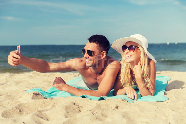 happy couple in swimwear walking on summer beach Stock photo © dolgachov