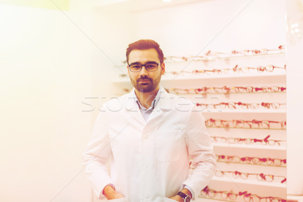 man optician in glasses and coat at optics store Stock photo © dolgachov