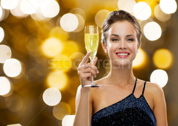 smiling woman holding glass of champagne Stock photo © dolgachov