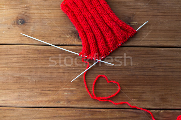 knitting needles and thread in heart shape on wood Stock photo © dolgachov