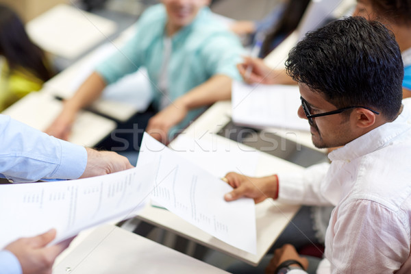 Stock photo: teacher giving exam test to student man at lecture