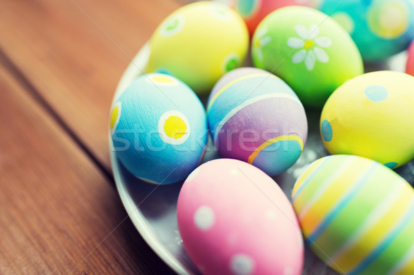 close up of colored easter eggs on plate Stock photo © dolgachov