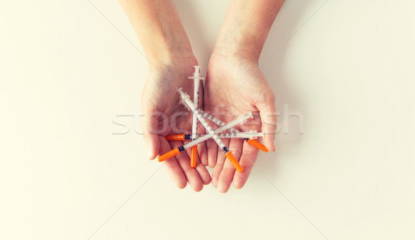 close up of woman hands holding syringes Stock photo © dolgachov