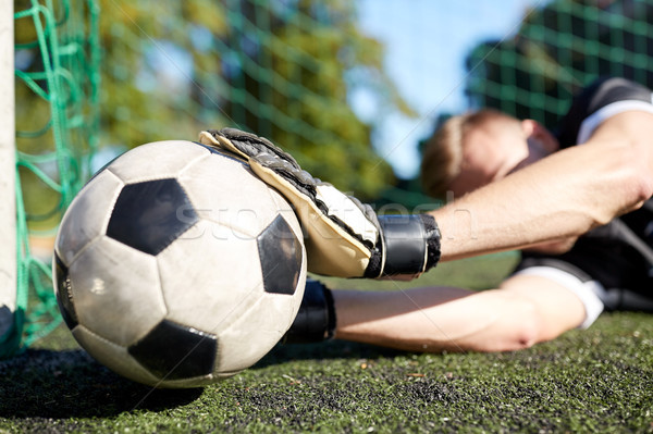 goalkeeper with ball at football goal on field Stock photo © dolgachov