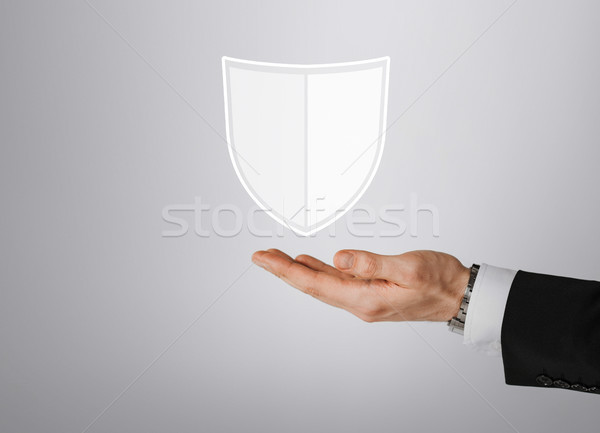 close up of man with virtual antivirus shield icon Stock photo © dolgachov