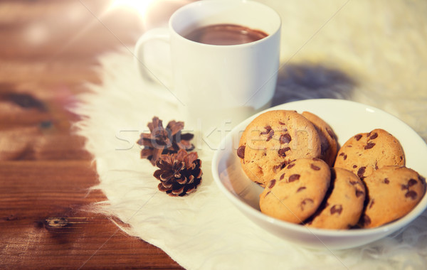 cups of hot chocolate with cookies on fur rug Stock photo © dolgachov