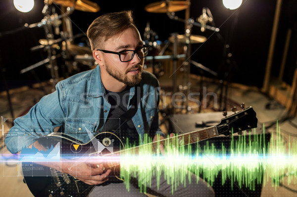 musician playing guitar at studio rehearsal Stock photo © dolgachov