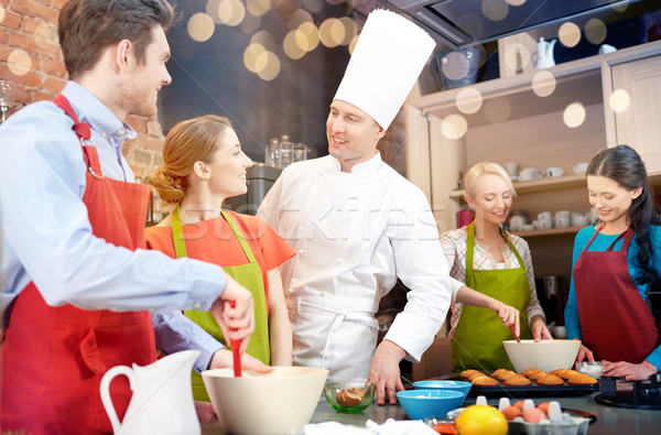 happy friends and chef cook baking in kitchen Stock photo © dolgachov