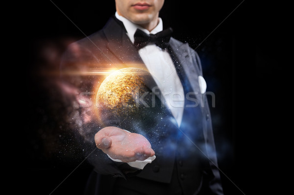 male magician with planet and space hologram Stock photo © dolgachov