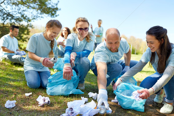 volunteers with garbage bags cleaning park area Stock photo © dolgachov