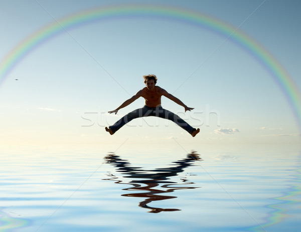 jump over water under rainbow  Stock photo © dolgachov