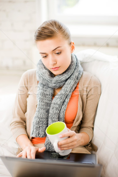 diseased woman in scarf using laptop at home Stock photo © dolgachov