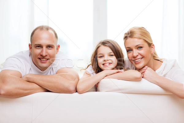 smiling parents and little girl at home Stock photo © dolgachov