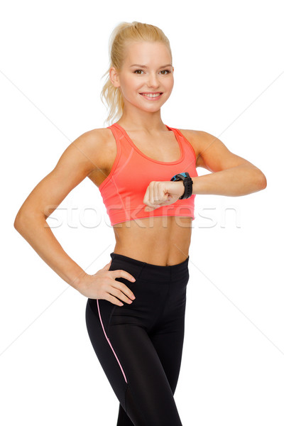 Donna sorridente frequenza cardiaca monitor mano fitness tecnologia Foto d'archivio © dolgachov
