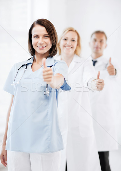 team of doctors showing thumbs up Stock photo © dolgachov