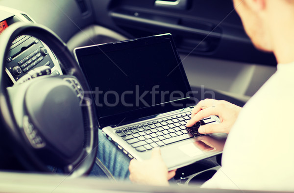 man using laptop computer in car Stock photo © dolgachov
