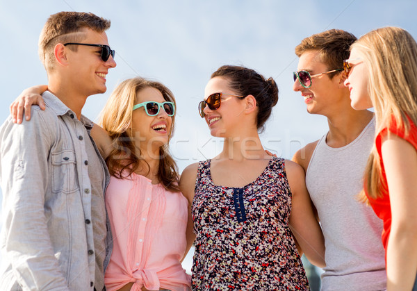 group of smiling friends in city Stock photo © dolgachov