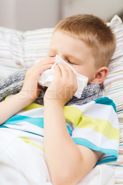 ill boy with flu at home Stock photo © dolgachov