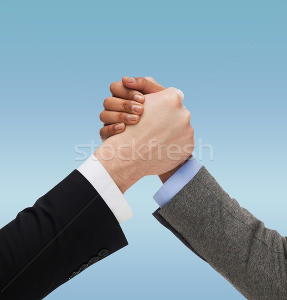 close up of two hands multiracial armwrestling Stock photo © dolgachov