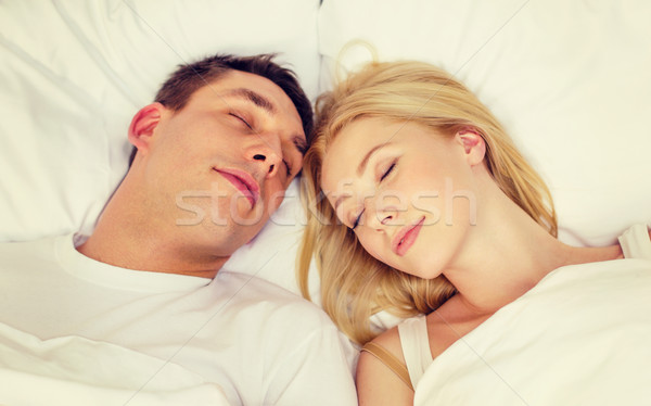 happy couple sleeping in bed Stock photo © dolgachov