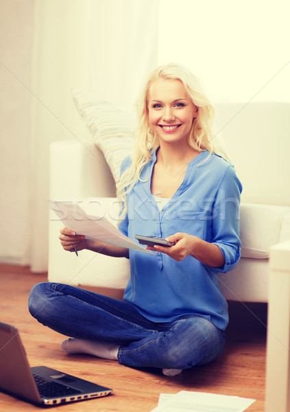 smiling woman with papers, laptop and calculator Stock photo © dolgachov