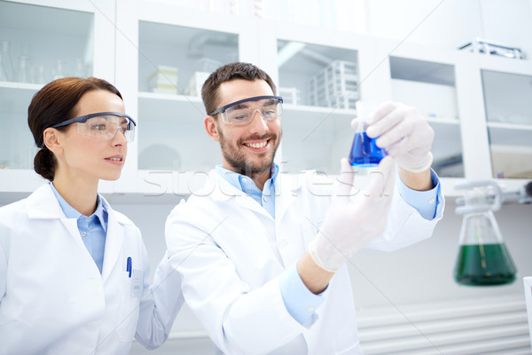 young scientists making test or research in lab Stock photo © dolgachov