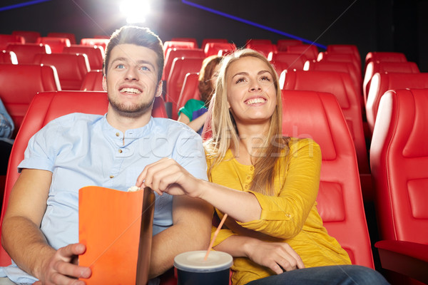 Stock photo: happy friends watching movie in theater