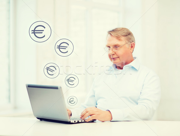 old man in eyeglasses working with laptop at home Stock photo © dolgachov