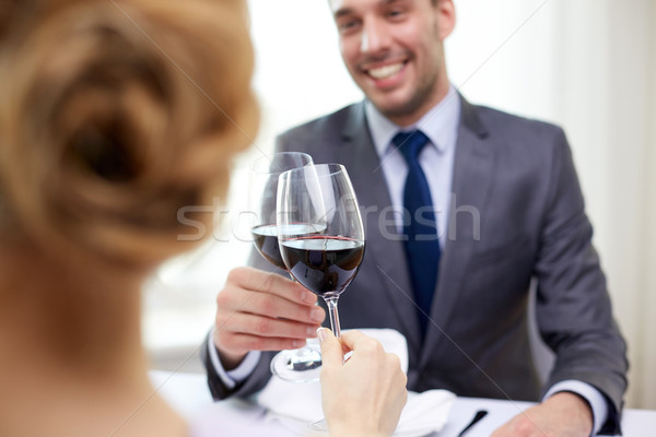 happy couple with glasses of wine at restaurant Stock photo © dolgachov