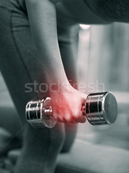 close up of woman with dumbbell exercising in gym Stock photo © dolgachov