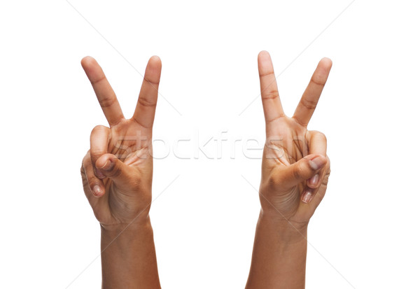 woman hands showing v-sign Stock photo © dolgachov
