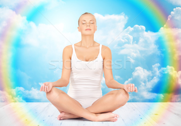 woman meditating in yoga lotus pose Stock photo © dolgachov