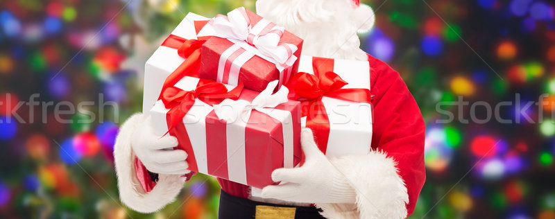 man in costume of santa claus with gift boxes Stock photo © dolgachov