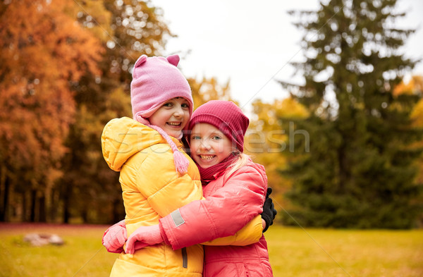 Stock photo: two happy little girls hugging in autumn park