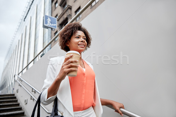 happy african businesswoman with coffee in city Stock photo © dolgachov