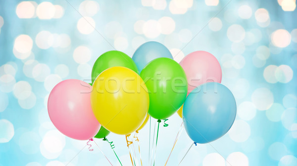 bunch of inflated helium balloons over blue lights Stock photo © dolgachov