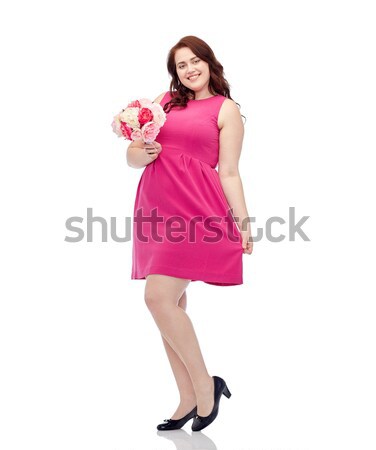 happy young plus size woman with flower bunch Stock photo © dolgachov