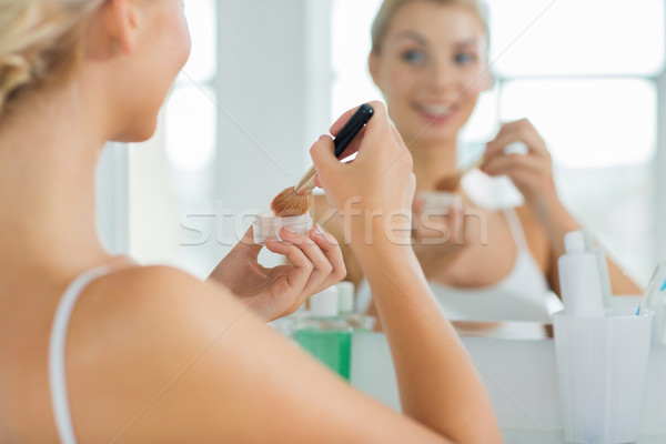 Stock photo: woman with makeup brush and powder at bathroom