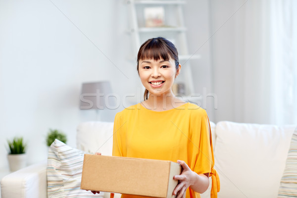 happy asian young woman with parcel box at home Stock photo © dolgachov